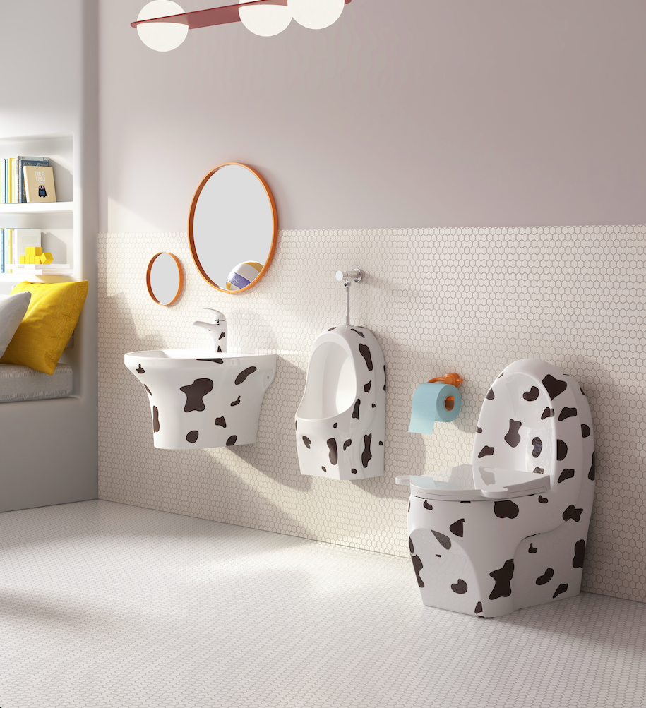 Bathroom with children's toilet and sink set featuring a cow print design.