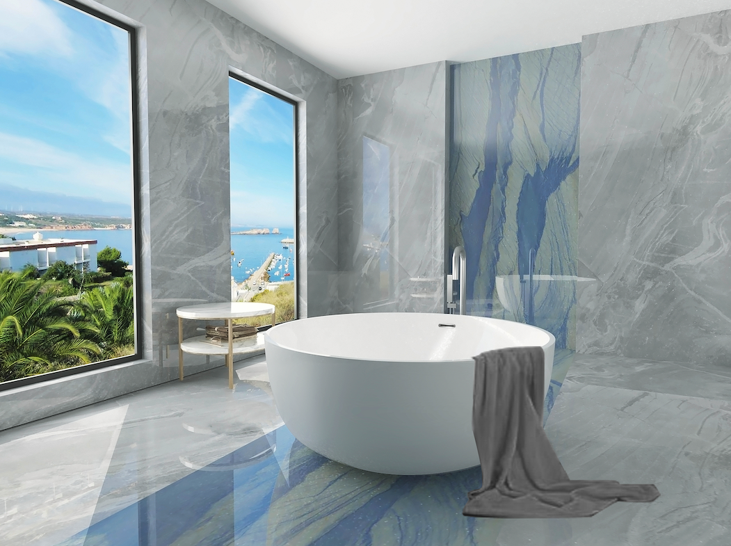 Modern acrylic bathroom with a freestanding bathtub, gray walls, and large windows overlooking a scenic view.
